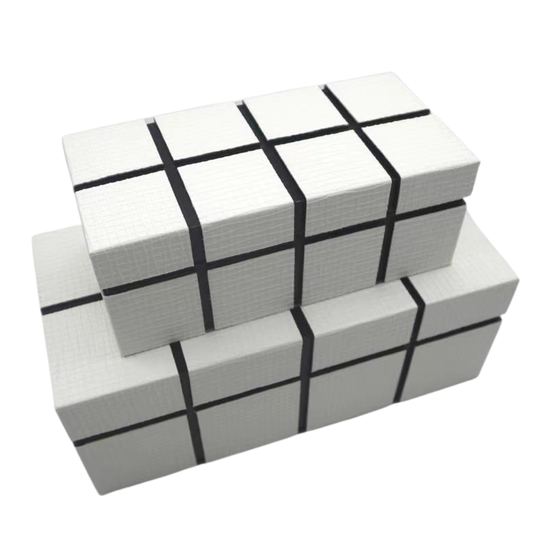 Storage white boxes with grid lines embossed stacked on each other