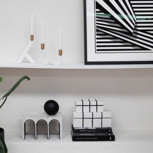 Arches Decor sculpture on a shelf for a modern decor. Triple Arched object made from resin and marble. A ball object sits on the top of the sculpture.