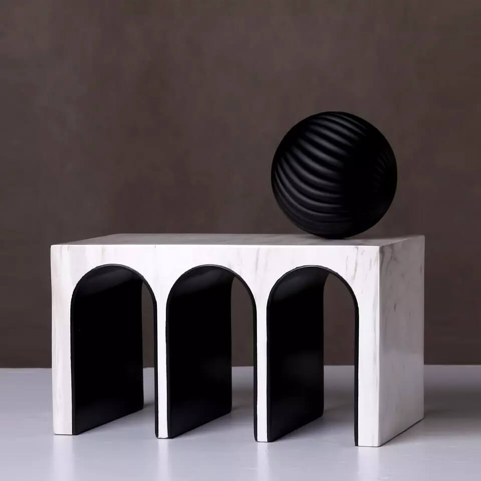 Triple Arched object made from resin and marble. A ball object sits on the top of the sculpture.