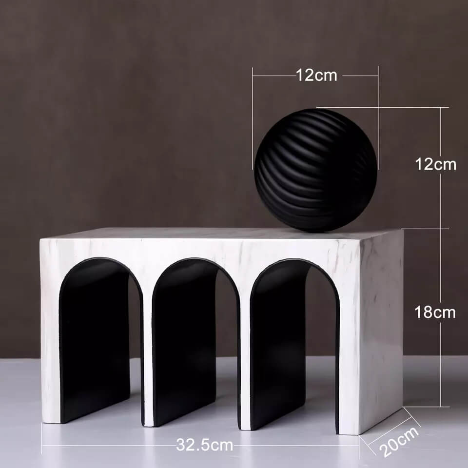 Triple Arched object made from resin and marble. A ball object sits on the top of the sculpture.