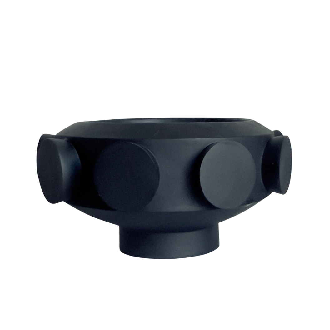 A resin large pedestal bowl with black cylinders on the exterior