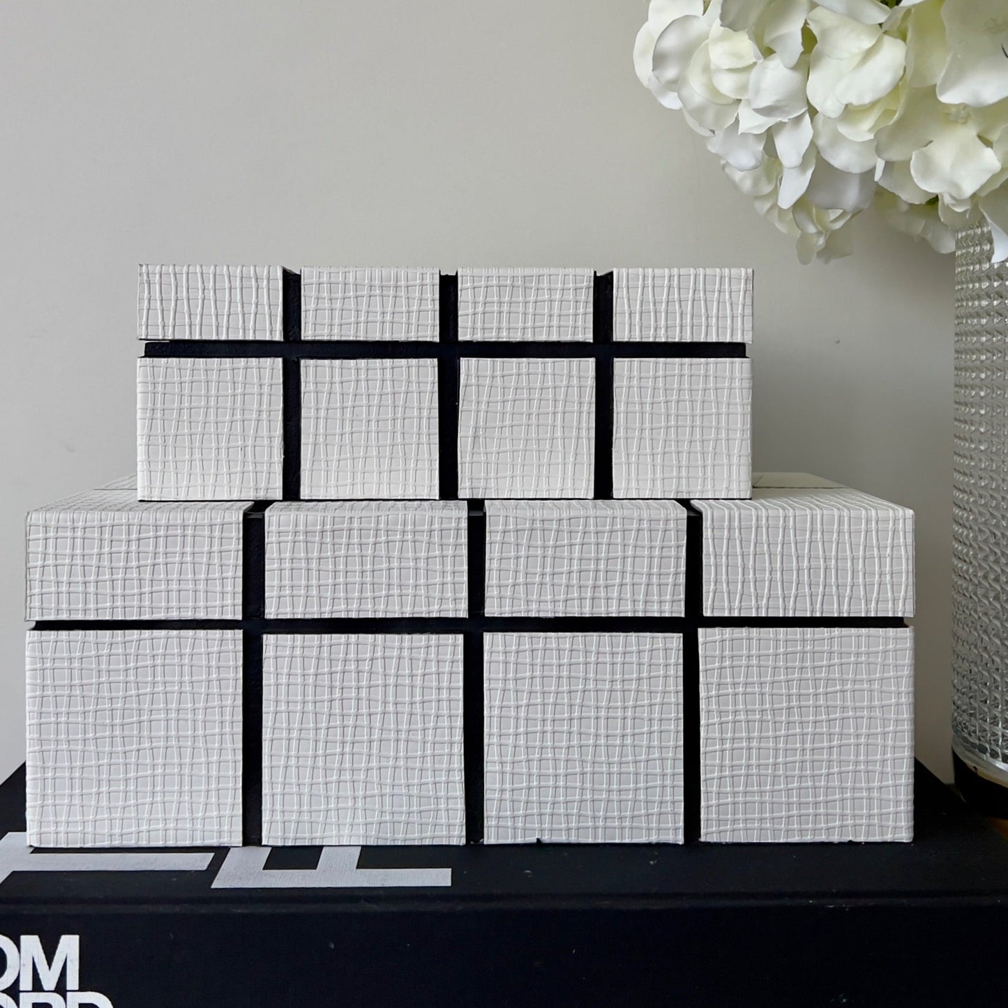 Storage white boxes with grid lines embossed stacked on each other